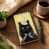 Carnet chat noir illustre sur un bureau avec cafe