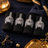 Chaussettes chat noir a pompon roulees sur fond bleu nuit