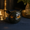 Figurine chat noir sur fond bleu nuit