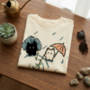 T-shirt chat noir plie en flat-lay