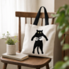 Tote bag chat noir pose sur une chaise